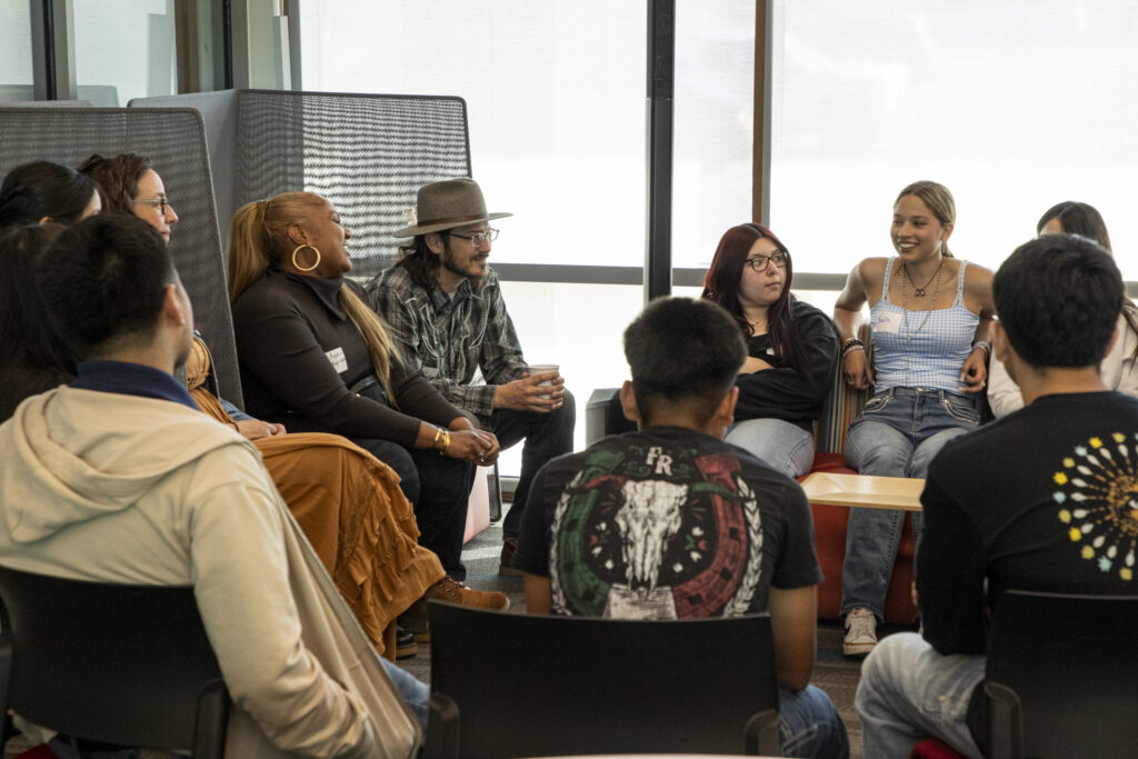 A group of participants laugh during a Story Exchange workshop.